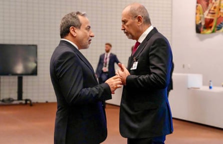 Araghchi and Safadi stand facing each other in conversation