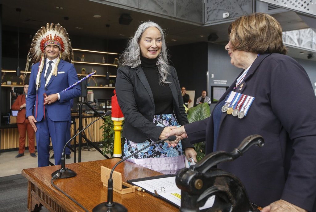 Manitoba Premier Wab Kinew looks on as Nahanni Fontaine, Minister of Families, Minister responsible for Accessibility, Minister responsible for Gender Equity is sworn-in by Lt. Gov. Anita Neville at a Premier and cabinet swearing-in ceremony in Winnipeg, Wednesday, Oct. 18, 2023.