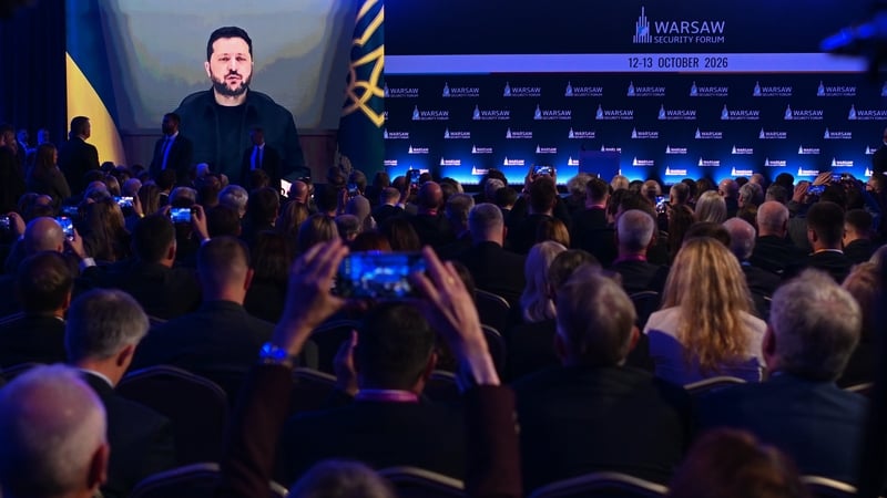 People watch as Volodymyr Zelensky addresses them remotely