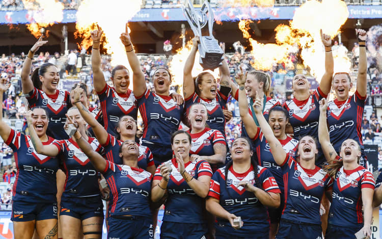The Sydney Roosters holds aloft the NRLW Premiership Trophy after beating Brisbane in the grand final.
