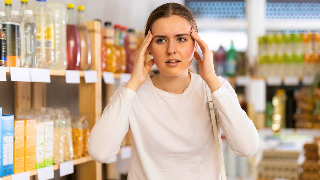 young woman feeling annoyed while running errands